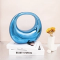 Metallic blue acrylic moon bag with reflective mirror finish and modern ring handle style - Blue