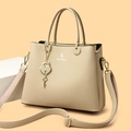Beige lychee leather tote bag with dual handles and heart-shaped gold padlock charm - Khaki