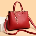 Elegant red leather tote bag with lychee texture and heart pendant charm - Red
