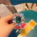 Detailed macro view of an emerald green sunflower gem with rainbow crystal petals - Expanding Stand / Emerald