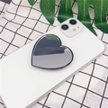 Close-up of heart-shaped makeup mirror phone grip on white smartphone with black trim - Heart Shape (Airbag Stand) / Black Border Mirror