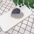 Macro detail of a heart-shaped makeup mirror phone stand in gold and silver finish - Heart Shape (Airbag Stand) / Gold Border Mirror