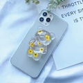 Detailed view of a transparent bear phone grip featuring real yellow dried flowers - Yellow Plum Blossom Bear