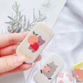 Close-up of cute cartoon bear phone socket stand with cherry illustration on white fabric - Quokka with Persimmon Style(3)