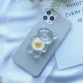 Close-up of a clear bear phone grip with a real white dried flower on a green phone - White Chrysanthemum Bear