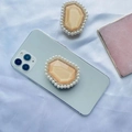 Close-up of pearl and diamond expandable phone socket with champagne gemstone on violet silk - Yellow with Pearl Border