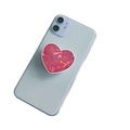 Pink heart-shaped griptok with sparkling crystal texture on a blue smartphone - Heart Pink Laser