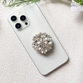 Detailed view of luxury flower shape phone socket with glittering crystals on white smartphone - Transparent Crystal (Full Diamond - Airbag Stand)