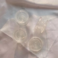 Set of four transparent DIY folding cell phone sockets on white satin background - Round Transparent Flat