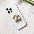 Detail of luxury gold phone grip with radial pearls and intricate hollow carvings - Gold Six-Petal Pearl (Five Pearls - Airbag Stand)