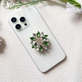 Close-up of luxury floral rhinestone phone grip with green and clear crystals on a white phone - Green Transparent Diamond Flower (Small Green Diamond - Airbag Stand)