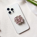 Detailed close-up of a luxury crystal-encrusted phone grip with pink rectangular gemstone - Pink Cut Gem (Rose Quartz - Airbag Stand)