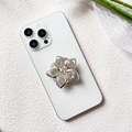 Close-up of luxury flower-shaped phone socket with sparkling crystals on white phone - Silver Five-Petal Flower (Cherry Blossom Diamond - Airbag Stand)