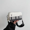 Crossbody bag with piano key pattern and embroidery in a white and black musical theme - White