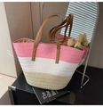 Close-up of pink and white striped woven straw tote bag with brown leather handles - Pink White