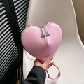 Chic pink heart-shaped crossbody bag with clover zipper pulls and leather shoulder strap - Pink