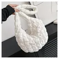 Close-up of white quilted cloud bag showing soft puffy texture and sleek modern handle - Large / White