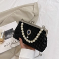 Black beaded clutch with pearl handle and vintage blue gemstone brooch detail - Black