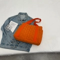 Quilted puffer tote bag in vibrant orange featuring wide nylon straps and large capacity - Orange