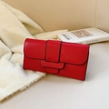 Minimalist red long clutch wallet with black contrast piping on soft faux fur background - Red