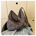 Dettaglio della borsa tote in tela con stampa leopardata appoggiata su una sedia - Leopardo Caffè