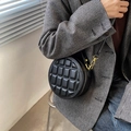 Modern black round crossbody bag with geometric chocolate quilted texture and gold metal hardware - Charcoal Black