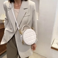 Chic white quilted round handbag with gold hardware and a slim adjustable shoulder strap - Milk Color