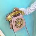 Pink retro telephone shaped handbag with metallic gold handle and crossbody strap - Pink