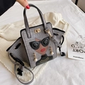 Grey crocodile embossed handbag with fashion portrait design and pearl drop detail - Gray