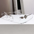 Frameless oval sunglasses with silver metal temples and floral rhinestone detailing - Bright Nickel Anti-Blue Light (Clear)