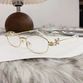 Golden metal polygon sunglasses with pink gemstone and star detail on table - Bright Gold Blue Light Blocking