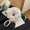 Unique white flower shaped handbag with pearl handle and green leaf detail in glossy PU - White