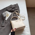 Chic beige leather bucket bag with top handle and adjustable shoulder strap for women - No Pendant / Off-white