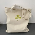Cream canvas tote bag with green clover embroidery for women, large capacity shoulder bag - Beige
