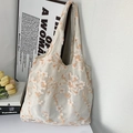 Detailed embroidery of orange flowers on a white translucent mesh tote bag - Gypsophila Embroidery Lotus Pink Bag