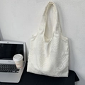 Detailed texture of white leaf patterns on a stylish commute tote bag with a laptop - Textured Leaf Embroidery (White)