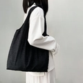 Minimalist black tote bag with textured leaf pattern for casual summer use - Black Leaf Texture