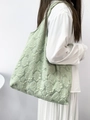 Mint green tote bag with rose embossed texture shown on model in a minimalist style - Pale Green