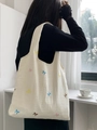 Detailed close-up of colorful butterfly embroidery on off-white canvas tote bag texture - Mini Colorful Bow Embroidery (Beige)
