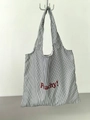 Detail view of large striped nylon tote bag with red Peachy! handwritten text print - Black and White Fine Stripe (Peachy Dark Red Letters)