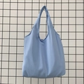 Detail view of a soft light blue canvas tote bag showing textured cotton fabric and large capacity - Sky Blue