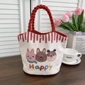 Detail of canvas bucket bag featuring cute cartoon animal prints and red woven handles - Happy Bear