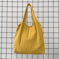 Detail of a bright yellow canvas tote bag showing fine fabric texture and sturdy handle - Ginger Yellow