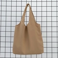 Close-up of khaki canvas tote bag showing thick textured fabric and sturdy stitching - Khaki