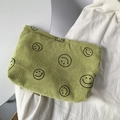 Light green corduroy storage bag with black smiley face pattern on white surface - Green Smiley Face Storage Bag