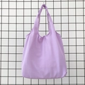 Close-up of a light purple cotton canvas tote bag hanging on a minimalist metal grid - Light Purple