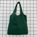 Detail of dark green canvas tote bag fabric texture and wide shoulder strap - Dark Green