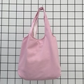 Detail view of pink tote bag showing ripple texture fabric and wide shoulder strap - Pink