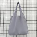 Detail shot of light purple canvas tote bag texture with minimalist seamless handles - Gray
