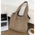 Detailed herringbone wool tote bag with ATRYG label shown near laptop and coffee cup - Khaki
